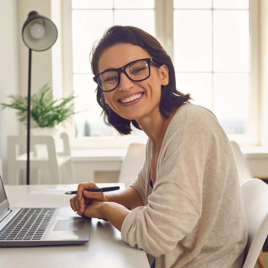 Woman smiling while using computer