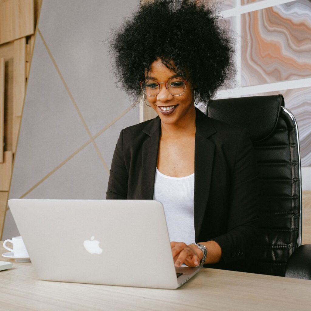 Woman smiling while using laptop