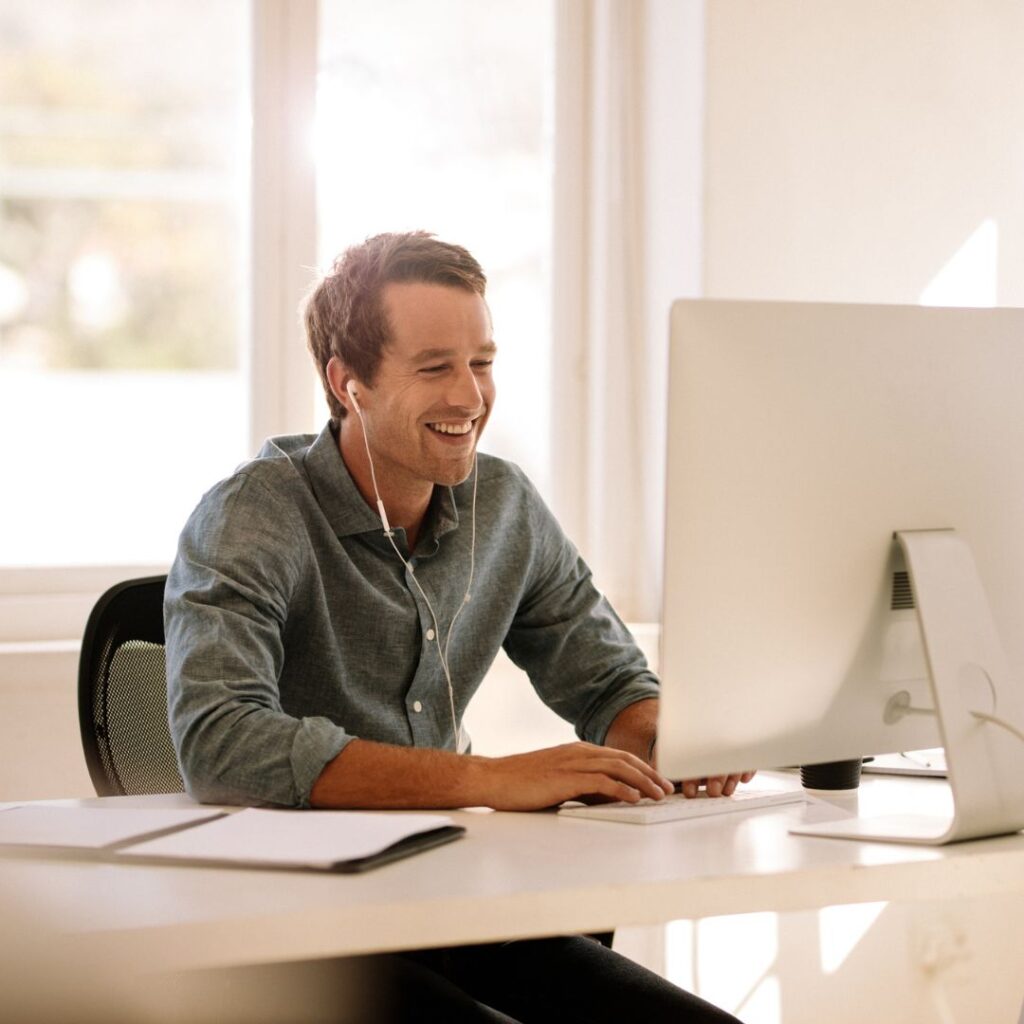 Man smiling working on computer