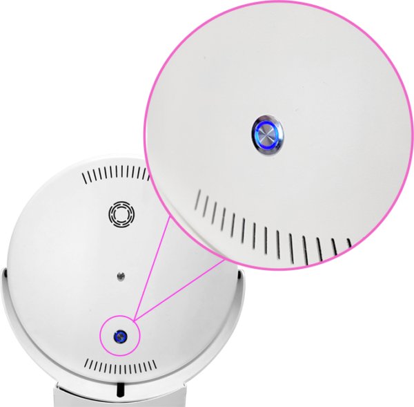 An image showing the back of a white circular photo booth head, with a pink circle and magnifying lines highlighting a close-up of a small, metallic power button illuminated with a blue LED ring.